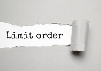 limit order text on white torn paper