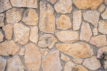 Wall built with granite stones and joined with cement.