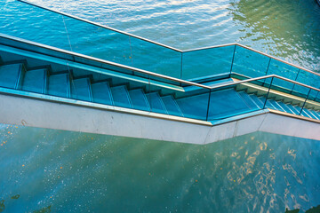 Staircase over the river with glass railings