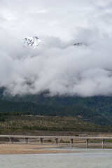 Slow moving clouds over the pine forest covered mountains