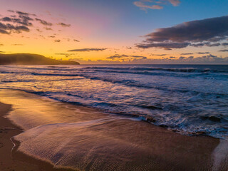 Aerial sunrise at the beach with clouds