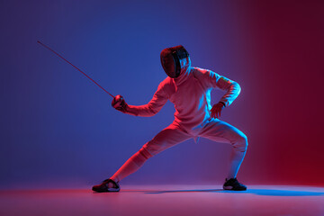 Male fencer with smallsword practicing fencing isolated on purple background in neon light. Sport, energy, skills, achievements - obrazy, fototapety, plakaty