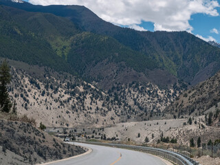 Winding asphalt road stretched into mountains