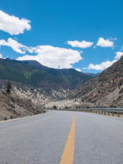 Winding asphalt road stretched into mountains