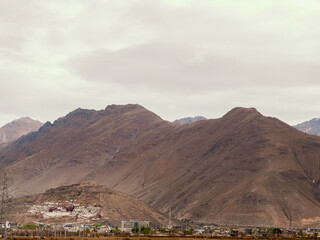 Ancient Tibetan palace on rocky barren mountains