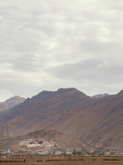 Ancient Tibetan palace on rocky barren mountains