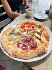 pizza with different toppings in a cafe