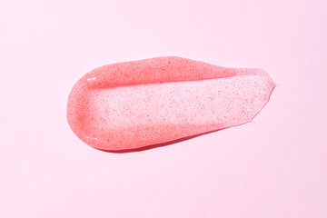 Cosmetic products jelly pinkscrub texture smudge on pink background. Skin care product presentation.
