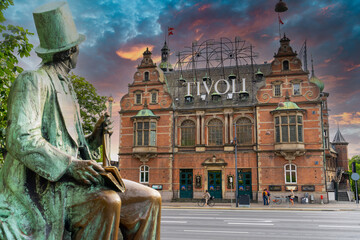Hans Christian Andersen statue and Tivoli building facade, built in 1843. Entrance to Tivoli Garden, one of the oldest operating amusement parks in the world.  Copenhagen - Denmark