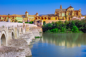 Fototapeta na wymiar Cordoba, Spain. Roman Bridge on Guadalquivir river and The Great Mosque (Mezquita Cathedral) in the city of Cordoba, Andalusia.