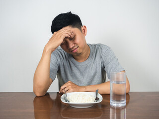 Depressed man sit with dinner on the table