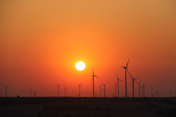 Obraz premium As the sun rose behind the hills, a brilliant golden light spread across the sky.
