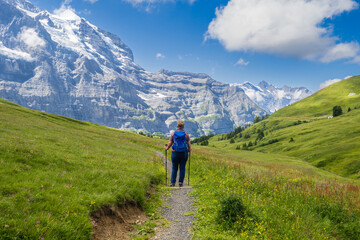 Hiking on the Eiger trail between Grindlewald and Wengen in the Swiss Alps - obrazy, fototapety, plakaty