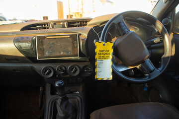 Safe workplaces practices yellow out of service warning tag sign placing on  ute power steering...