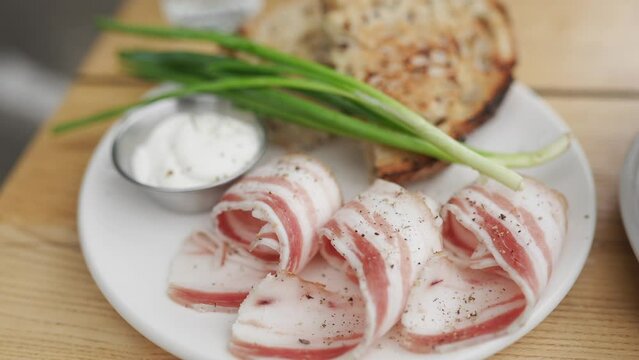 Slices of bread and lard with green onions