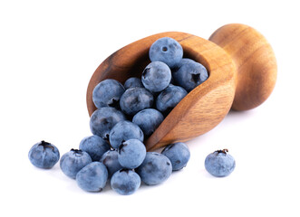 Fresh blueberry in wooden scoop, isolated on white background. Bilberry or whortleberry.