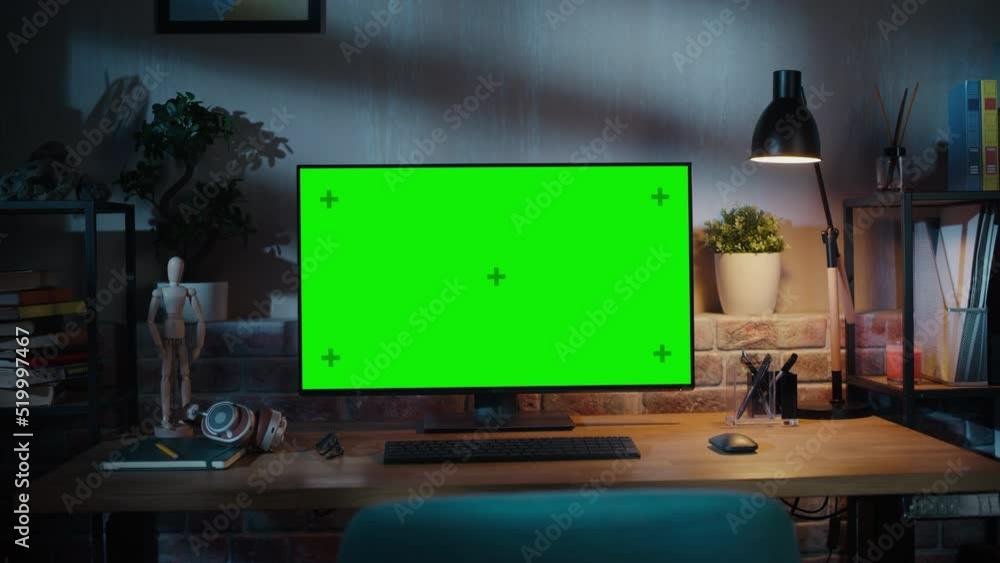 Poster modern personal computer monitor with green screen mock up display standing on the desk with keyboar