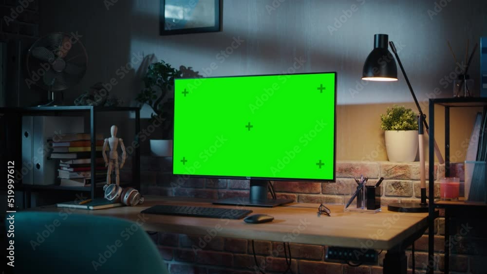 Poster computer monitor with green screen standing on a wooden desk with height adjustable function. chroma
