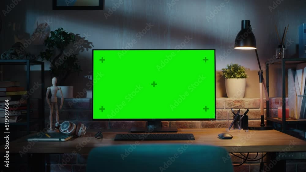 Poster Zoom in On a Modern Personal Computer Monitor with Chroma key Green Screen Display Standing on the Desk of a Cozy Home Office. Living Room Created by Interior Designer with Good Taste and Style.