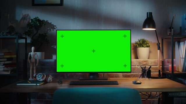 Zoom in On a Modern Personal Computer Monitor with Chroma key Green Screen Display Standing on the Desk of a Cozy Home Office. Living Room Created by Interior Designer with Good Taste and Style.