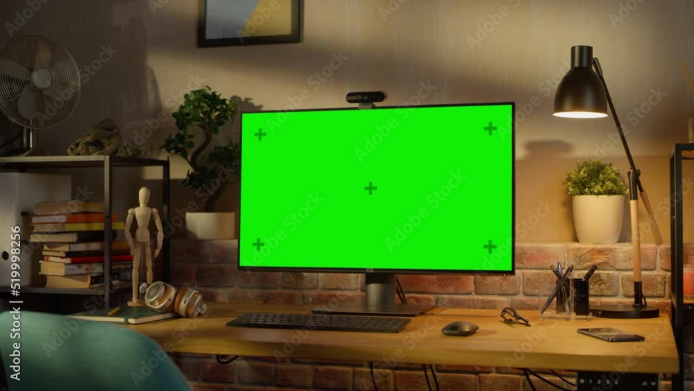 Poster computer monitor with green screen standing on a wooden desk with height adjustable function. chroma