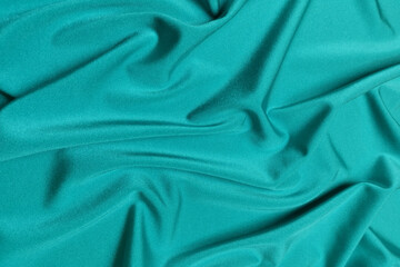 Blue crepe satin crumpled or wavy fabric texture background. Abstract linen cloth soft waves. Silk fabric. Smooth elegant luxury cloth texture. Concept for banner or advertisement.