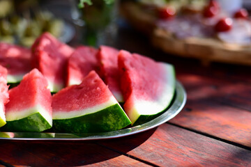 Sliced watermelon on a picnic table 