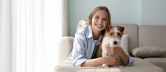 Portrait of young beautiful woman spending time with her adorable wire haired Jack Russel terrier...