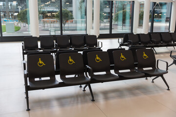 Reserved seats and signs for people with disabilities at Istanbul Airport terminal, Turkiye