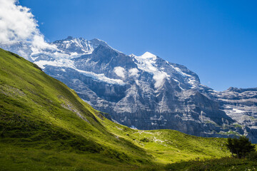 Fototapeta na wymiar Hiking on the Eiger trail between Grindlewald and Wengen in the Swiss Alps