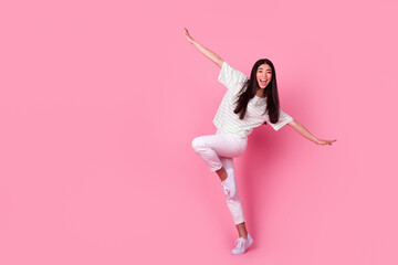 Full body photo of overjoyed cheerful person arms wings good mood empty space isolated on pink color background