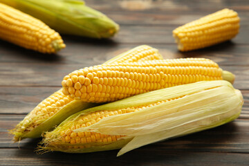 Fresh corn on cobs on rustic wooden table, closeup