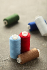 Fototapeta na wymiar Color sewing threads on grey background