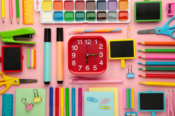 Different stationery on pink background. Back to school