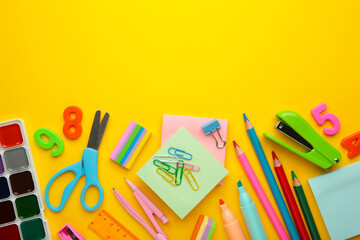 School supplies on yellow background. Top view.