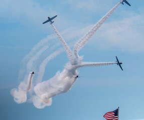 Skytypers precision performance team leaving a smoke design over an American Flag