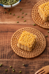 Delicious mung bean moon cake for Mid-Autumn Festival food mooncake on dark wood table background.