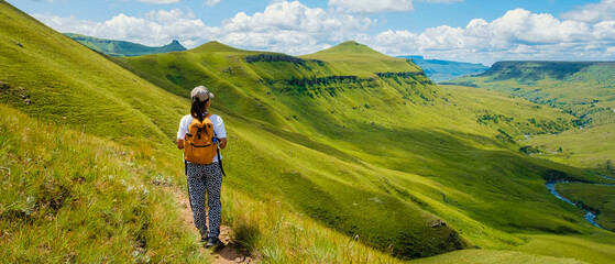 Young woman hiking in the mountains, .Drakensberg Giant Castle South Africa,Drakensberg mountain...