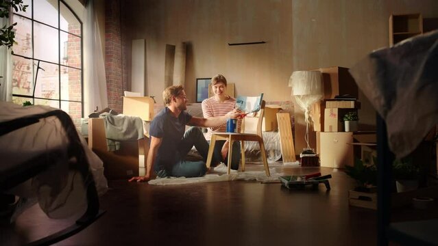 Moving in and Home Renovations: Couple in Love Painting Vintage Furniture Chair for New Cozy Home. Cheerful Young Family Make Apartment Comfortable with Art, Color. Smiles and Happiness