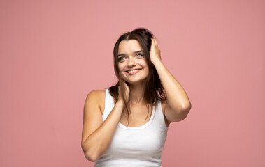 Attractive brunette woman with long hair being very glad smiling with broad smile showing her teeth and having fun indoors. Joyful excited cheery female.