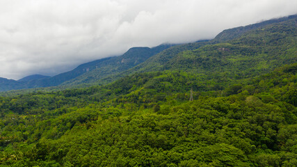 Aerial view of Mountains with rainforest and agricultural land in a mountainous province in Sri Lanka.