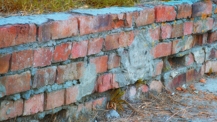 Old wall made of different red bricks