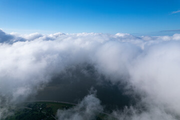 Fototapeta na wymiar Flying over beautiful fluffy clouds