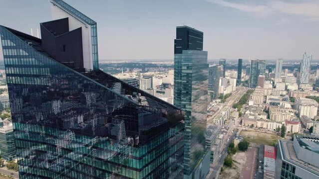 The top of Skyliner skyscraper. The Skyliner as a central point of quickly developing Wola district. Aerial perspective. Blue sky. High quality 4k footage