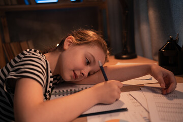 Distressed girl gives up, child do online elementary school homework at night. Stubborn kid refuses to study sick and tired of virtual class, homeschooling