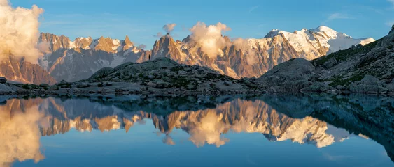 Photo sur Plexiglas Mont Blanc The panorama of Mont Blanc massif  Les Aiguilles towers and Grand Jorasses over the Lac Blanc lake in the sunset light.
