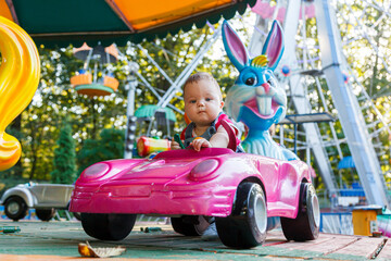 Obraz na płótnie Canvas handsome little boy on amusement ride machine