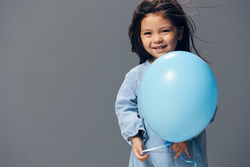 little girl posing with a blue balloon