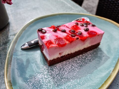 vegan pink cake on a ceramic plate closeup photo