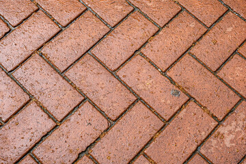 Abstract background from paving red tiles, bricks. Top view of the pavement pattern. Concept for construction, urban environment improvement, finishing works, landscape design.